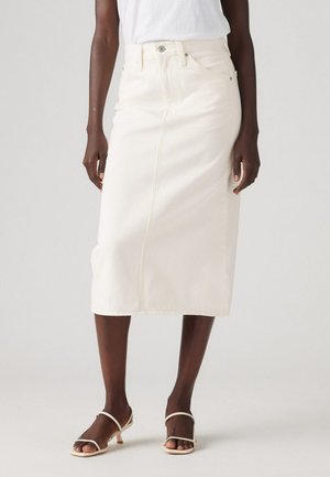 Hvit denim midi-skirt med rett snitt, frontlommer og synlige sømmer. Kombinert med lysfargede åpne hæler.