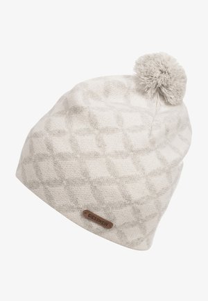 Bonnet d'hiver tricoté beige clair avec un motif en losange subtil, un pompon sur le dessus et une petite étiquette en cuir de la marque indiquant "Giesswein".