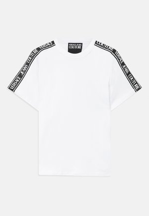 White short-sleeve t-shirt with black branded tape reading "Versace Jeans Couture" along shoulders and neck label.