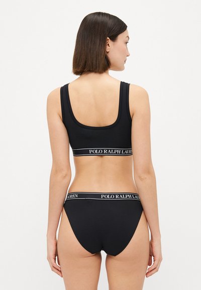 Black bralette and matching panties with thick straps and elastic waistband featuring the "Polo Ralph Lauren" logo in white text.