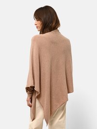 Poncho beige realizzato in tessuto morbido, con una vestibilità rilassata, design drappeggiato, scollo a V e orlo asimmetrico con una sottile texture.