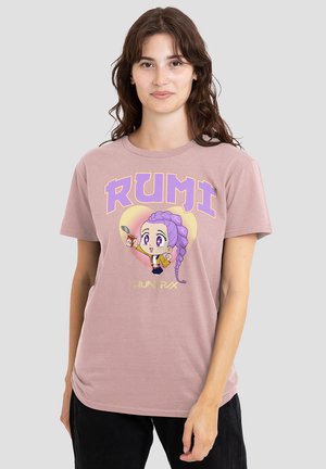 Rosa Baumwoll-T-Shirt mit einer Cartoonfigur mit lila Haaren und großen Augen, Text "RUMI" in fettem Gelb und Lila, auf einem neutralen Hintergrund.