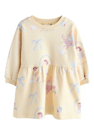 Robe pour enfant à manches longues de couleur crème avec col et poignets en maille, avec des illustrations de lapins, filles, nœuds et le mot « amitié ».