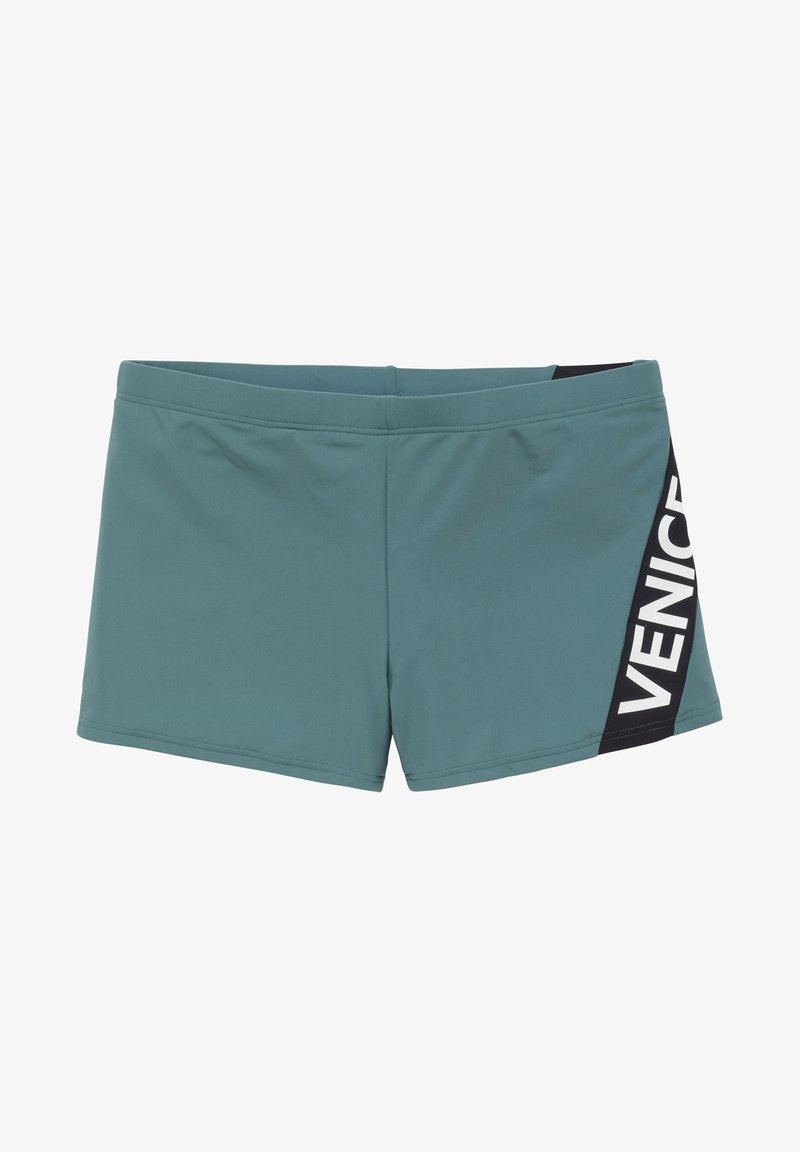 Tyrkysové plavky s čiernym panelom, na ktorom je slovo "VENICE" v bielej farbe. Vyrobené z elastického materiálu; štíhly, obdĺžnikový dizajn.