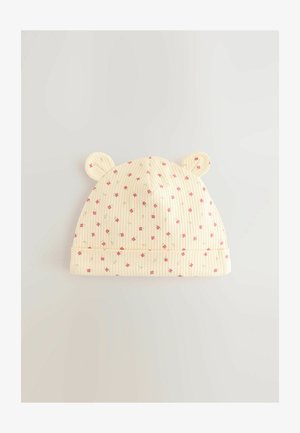 Gorro de bebé amarillo con acanalado y patrones florales en rosa, con orejas redondeadas y un borde doblado. Textura de tela suave en todo el gorro.