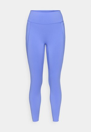 Leggings taille haute en bleu vif, fabriqués dans un matériau extensible. Présentent une texture lisse avec des coutures latérales et une coupe ajustée.