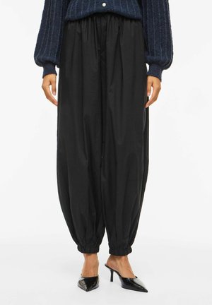 - Spodnie materiałowe