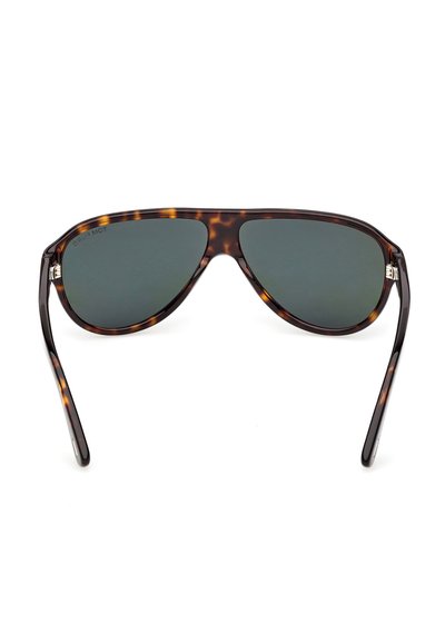 Lunettes de soleil aviateur en écaille avec des verres verts foncés et des branches fines courbées sur fond blanc.