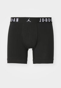 Sorte boxershorts lavet af blødt stof med en strækbar talje, der har "Jordan"-logoet i hvid skrift.
