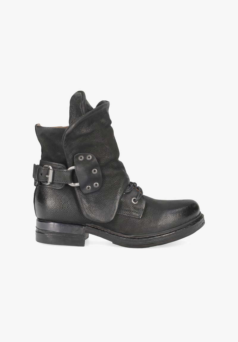 Black leather ankle boot with a slouchy collar, buckle detail, textured finish, and a low stacked heel. Features lace-up closure.