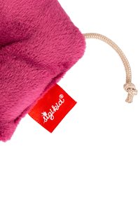 Bright pink plush fabric with a textured surface, featuring a tan drawstring and a red label with white text and a small logo.