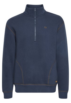 Tamsiai mėlyna megztinis su puse užtrauktuko, kontrastingais siūlais ir mažu logotipu ant krūtinės. Minkšta medžiaga, su gumuotomis rankogalių ir apačios kraštinėmis.