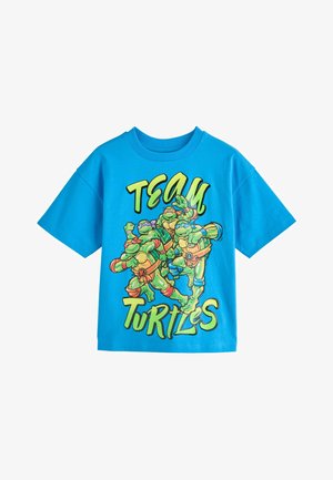 Helles blaues Kurzarmhemd mit den Teenage Mutant Ninja Turtles in Aktionsposen und dem Schriftzug "TEAM TURTLES" in grünen und gelben Buchstaben.