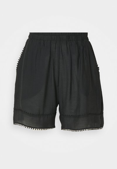 Black shorts made of lightweight fabric with an elastic waistband, featuring side pockets and a decorative pom-pom trim along the hem.