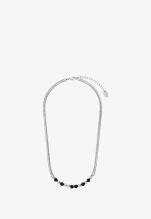 Srebrny naszyjnik z elastycznym, ryflowanym łańcuszkiem, z rzędem przemiennych czarnych i srebrnych koralików, zapięty na karabińczyk.