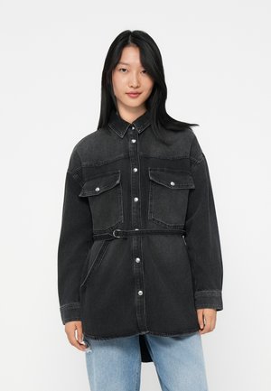 Dark gray denim shirt jacket with two front pockets, belt detail, and silver snap buttons. Long sleeves and a relaxed fit design.