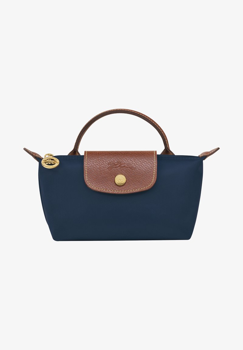 Navy blue nylon bag with a brown textured leather flap, gold hardware, and a short handle. Features a rounded shape and stitched accents.