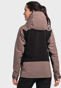 Water-resistant jacket featuring a black and taupe color scheme, adjustable hood, and fitted cuffs for enhanced warmth and comfort.