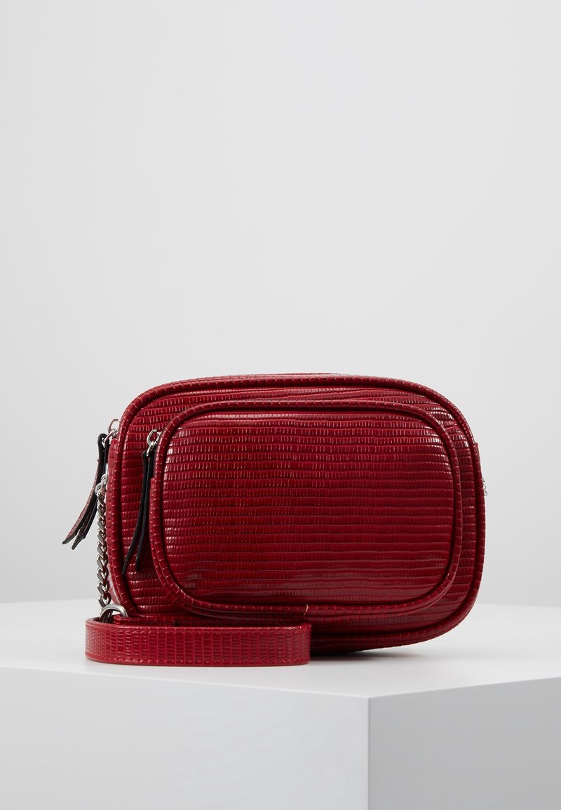 Borsa a tracolla in faux leather rossa con texture impresso, doppi scomparti con zip e tracolla removibile. Dettaglio con catena.