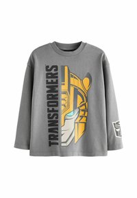 Graues Sweatshirt mit langen Ärmeln, das ein Transformers-Design in Gelb und Blau zeigt, mit fettem Text an der Seite und dem Logo am Ärmel.