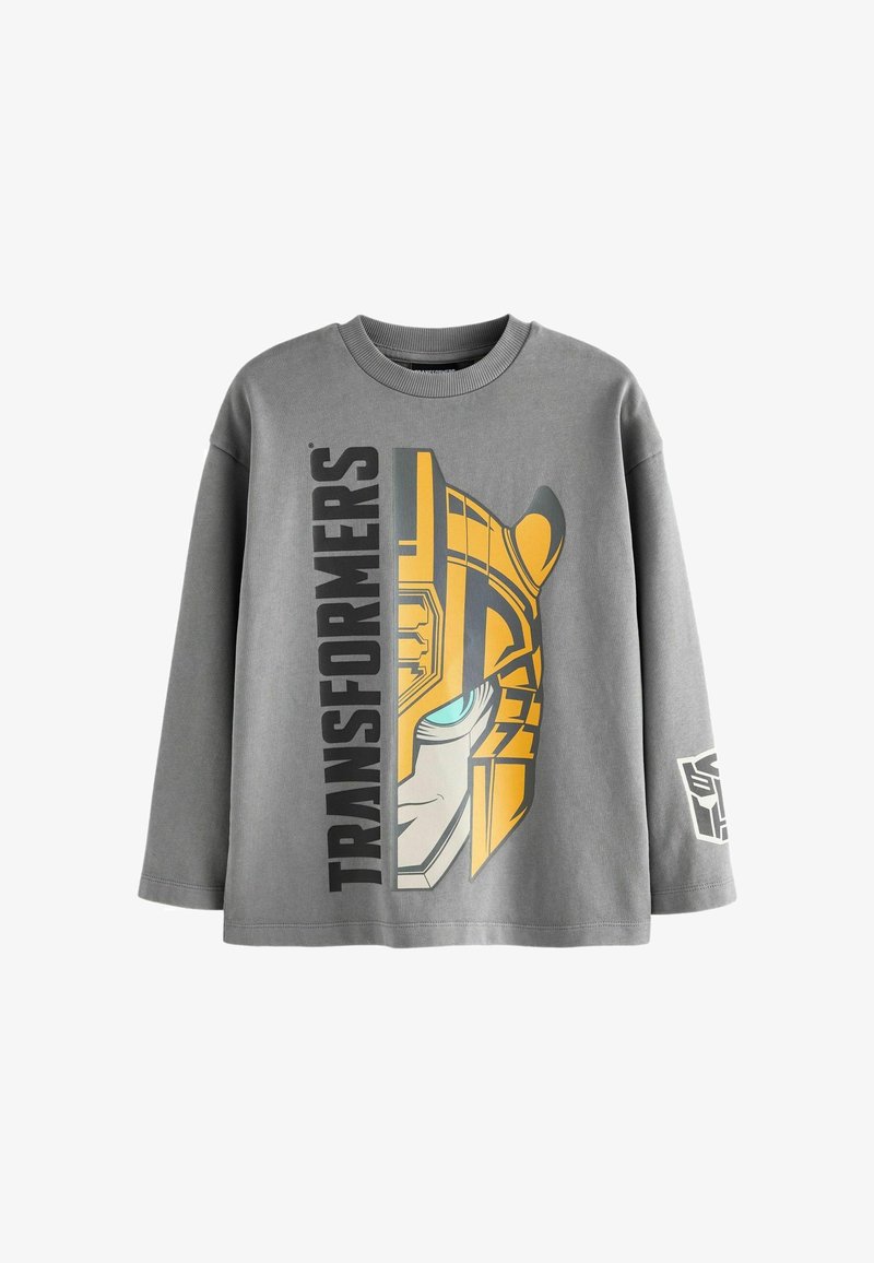 Pilkas ilgomis rankovėmis megztinis su Transformerių grafika geltona ir mėlyna spalvomis, ant šono su ryškiu tekstu ir logotipu ant rankovės.