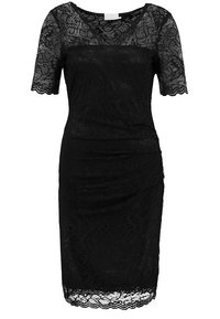 Robe noire en dentelle jusqu'aux genoux, à manches courtes, silhouette ajustée, avec des bords festonnés aux manches et à l'ourlet.