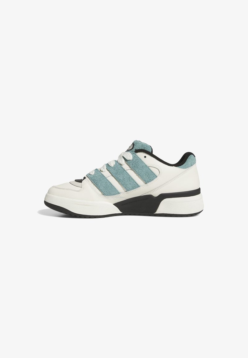 White sneaker with turquoise suede stripes, black accents, and a textured rubber sole. Features lace-up design and round toe.