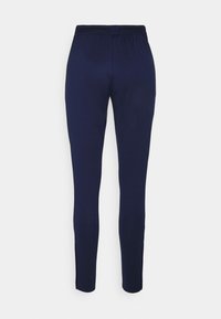 Pantalones azul marino hechos de una tela suave y elástica con una cintura elástica y aberturas laterales en el dobladillo para facilitar el movimiento.