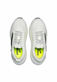 White running shoes with mesh upper, black accents, and reflective details. Features neon yellow insoles with "BROOKS" branding.