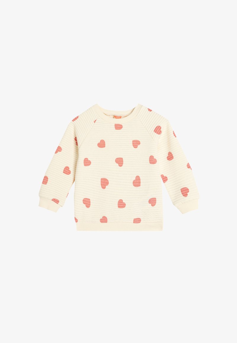 Felpa crema con un motivo testurizzato, caratterizzata da cuori rosa sparsi. Collo e polsini a coste, maniche raglan.