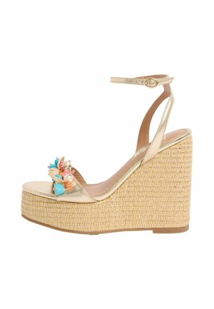 Gold wedge sandal with ankle strap, woven platform heel, and colorful bead and shell embellishments on toe strap.