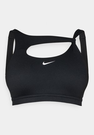 Svart sportbehå med mjuk textur, med en urklippt design och korsade band. En liten vit Nike-logotyp är placerad på framsidan.