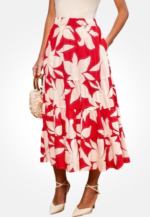Gonna a balze a fiori rossi con base color crema a contrasto, realizzata in tessuto leggero. Presenta una ampia vita elastica e tasche.