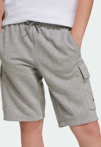Gray cotton blend cargo shorts with an elastic waistband and drawstring, featuring side pockets and a cargo pocket on the thigh.