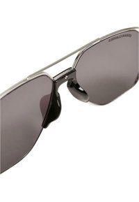 Sunglasses with a metal frame, dark tinted lenses, and a double bridge design. Black accents and a shiny finish on the frame edges.