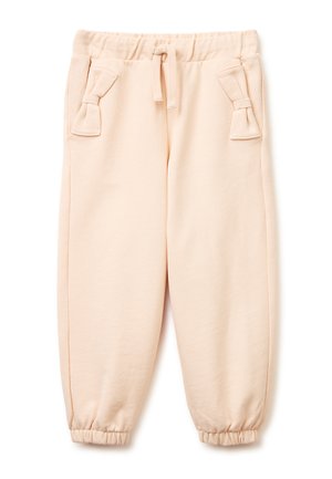 Beżowe dziecięce spodnie dresowe z elastycznym pasem i ściągaczami u dołu, boczne kieszenie ozdobione materiałowymi kokardkami oraz sznurek z przodu.
