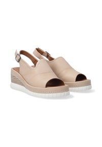 Beige leather slingback sandals with open toes, featuring a wedge heel with a textured design and a contrasting white sole.