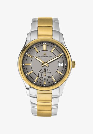 Reloj de esfera redonda con cara gris, caja de metal dorada y plateada, y brazalete a juego. Cuenta con marcadores de hora, subesfera y ventana de fecha.