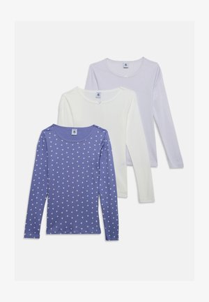 Trois chemises à manches longues disposées en couches : violet avec des cœurs blancs, blanc uni et violet clair avec de fines rayures.