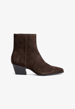 Brown suede ankle boots with a pointed toe, mid-block heel, and minimal stitching detail for a sleek appearance.