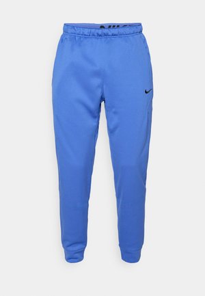 Pantaloni da tuta Nike blu realizzati in poliestere morbido, con vita elastica e un accento di logo discreto sul lato sinistro anteriore.
