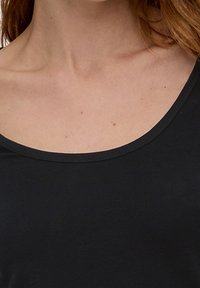 Schwarzes kurzärmliges Oberteil mit einem weiten, abgerundeten Halsausschnitt und glatter Oberfläche, hergestellt aus leichtem Stoff für optimalen Tragekomfort.