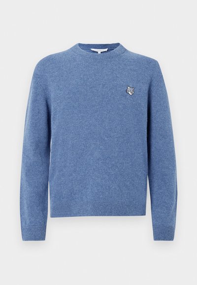 Modrý pletený sveter vyrobený z mäkkého materiálu, s okrúhlym výstrihom, dlhými rukávmi a malým vyšitým logom zvieraťa na hrudi.