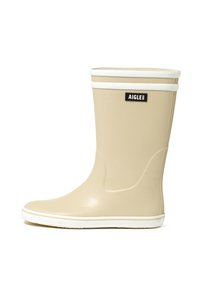 Stivale da pioggia in gomma beige con rifiniture bianche, asta dritta, punta tonda e suola testurizzata, con etichetta logo nera sul davanti.