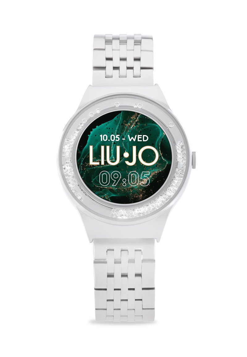 Sølv analog ur med en rund skive, der har en mørkegrøn marmorering som baggrund, gyldne detaljer og et tekstureret metalarmbånd.