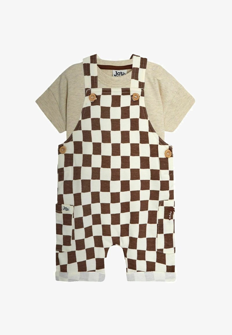 Chemise beige à manches courtes pour bébé avec une salopette courte à carreaux marron et blanc, attachée par des boutons en bois et dotée de poches latérales.
