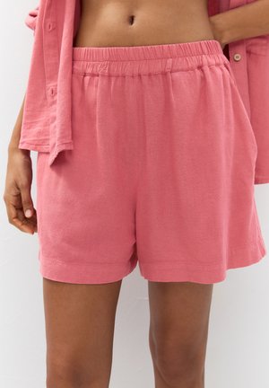 Lyserøde bomuldsshorts med elastisk talje, der har et afslappet fit og kantede manchetter. Letvægtsstof og blød tekstur.