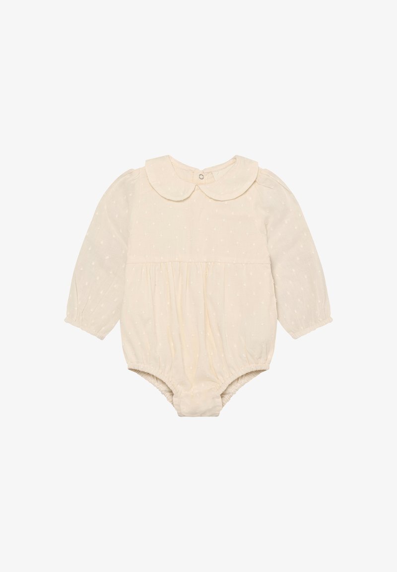 Body bébé de couleur crème à manches longues, col arrondi, avec des motifs en points texturés. Comprend des ouvertures élastiques pour les jambes et une fermeture à boutons.