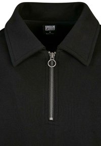 Mustat vetoketjulliset collarihuppari. Sisältää metallivetoketjun ja teksturoidun kankaan. Tunnuksessa lukee "URBAN CLASSICS", koko M.