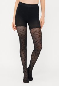 Sorte tights med et gjennomsiktig leopardmønster og en ugjennomsiktig toppstrikk. Elastisk materiale, glatt tekstur, tettsittende form, dekker kne til midje.